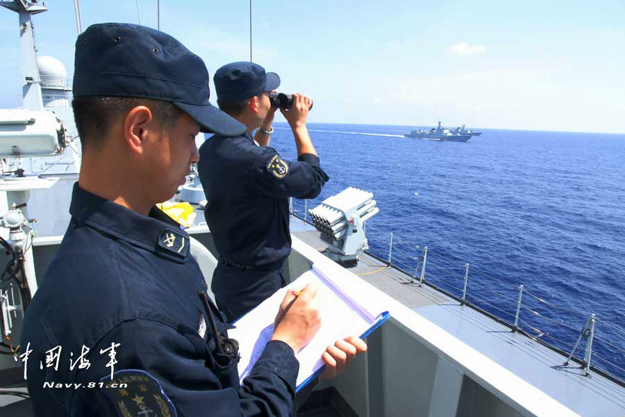 The picture shows the "Jinggangshan" amphibious dock landing ship, the "Lanzhou" guided missile destroyer, the "Yulin" guided missile frigate and the "Hengshui" guided missile frigate of the combat-readiness patrol and high-sea training taskforce under the South China Sea Fleet of the Navy of the Chinese People's Liberation Army (PLA) conducts training on the subject of battle-order deploying in the waters of the South China Sea on March 22, 2013. (PLA Daily/Qian Xiaohu Gao Yi and Gan Jun)