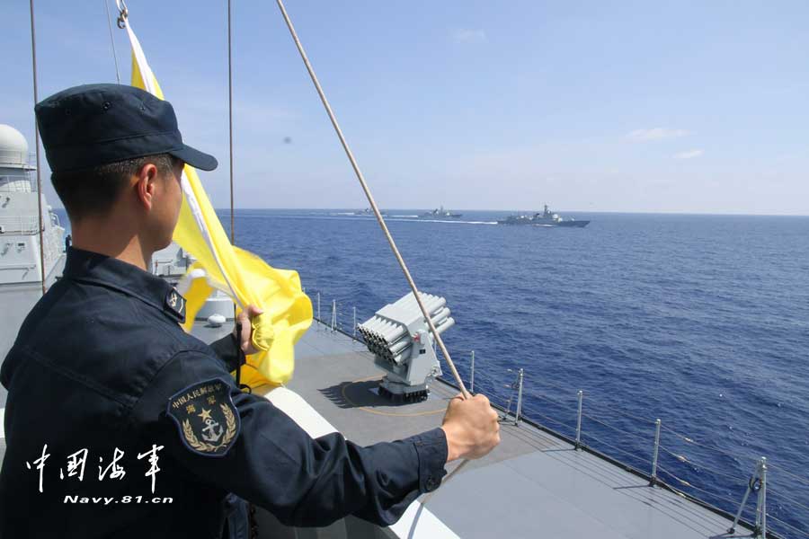 The picture shows the "Jinggangshan" amphibious dock landing ship, the "Lanzhou" guided missile destroyer, the "Yulin" guided missile frigate and the "Hengshui" guided missile frigate of the combat-readiness patrol and high-sea training taskforce under the South China Sea Fleet of the Navy of the Chinese People's Liberation Army (PLA) conducts training on the subject of battle-order deploying in the waters of the South China Sea on March 22, 2013. (PLA Daily/Qian Xiaohu Gao Yi and Gan Jun)