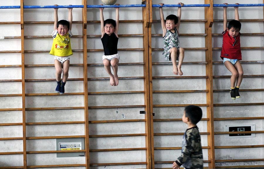 While children in urban areas are worn out with various training classes, rural students have to fight for their dreams. In 2009, some students are seen taking a training course at a youth sports school in Jiaxing, Zhejiang. Virtually all of them are the second generation of farmers, for whom the sports training might be a good opportunity to alter their fates. (Zhejiang Daily/Chu Yongzhi)