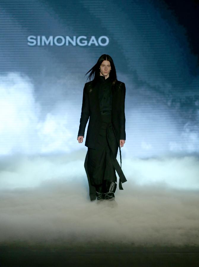 A model presents a creation during the SimonGao Collection as part of the China Fashion Week in Beijing, capital of China, March 25, 2013. (Xinhua/Chen Jianli) 