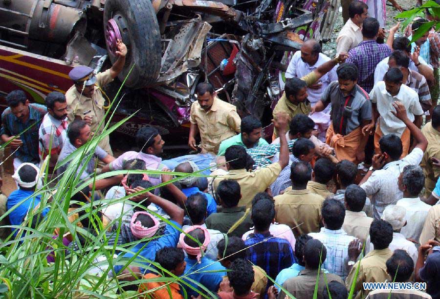 Local residents gather at the site of a bus accident at Idukki district of India's southern state Kerala, March 25, 2013. A school bus carrying students from Sarabhai Institute of Science and Technology fell into a deep ditch on Monday. (Xinhua/Stringer)