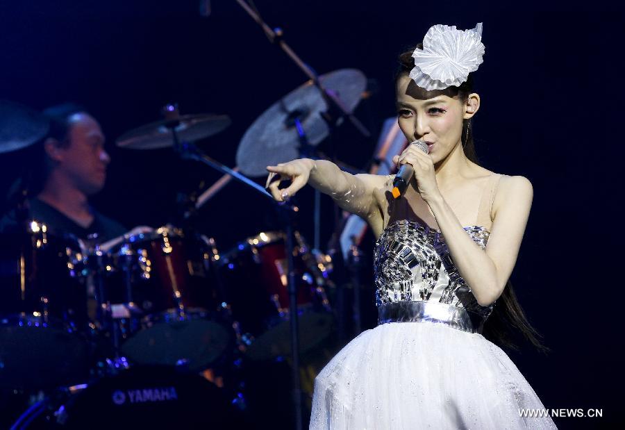 Singer Christine Fan performs during one of her world tour concerts at the O2 Indigo in London, capital of Britain, March 26, 2013. (Xinhua/Tang Shi) 