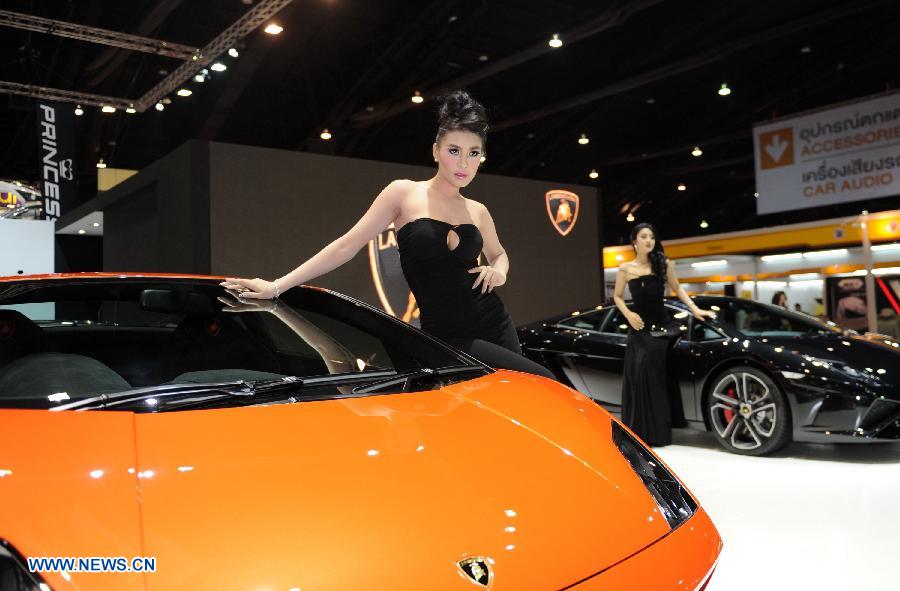 Models pose beside a Lamborghini roadster during the press preview of the 34th Bangkok International Motor Show in Bangkok, Thailand, on March 26, 2013. The 34th Bangkok International Motor Show will be held from March 27 to April 7. (Xinhua/Gao Jianjun)  