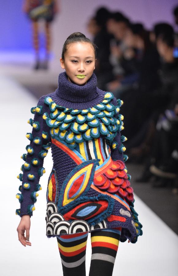 A model presents a creation in the WSM China Knitwear Fashion Design Contest 2013 during the China Fashion Week in Beijing, capital of China, March 26, 2013. The design by Sheng Lina from Fashion School & Engineering of Zhejiang Sci-Tech University won the championship of the contest. (Xinhua/Li Xin) 