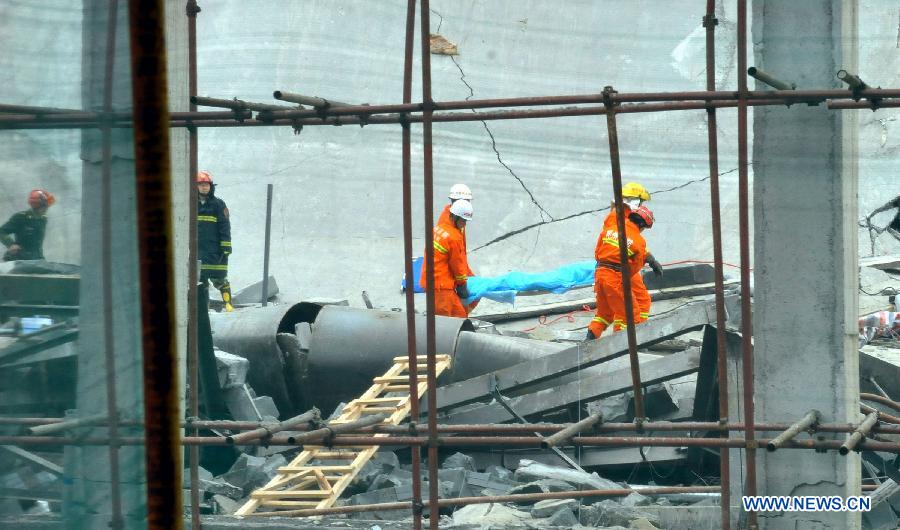 Firefighters carry out a wounded person at the scene of a building collapse accident in Zixing City, central China's Hunan Province, March 27, 2013. Part of a hotel under construction collapsed on Wednesday morning, which buried six people, five of whom have been rescued. (Xinhua)