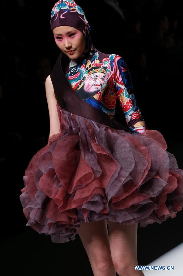 A model presents a creation designed by students of Minzu University of China during the China Fashion Week in Beijing, capital of China, March 27, 2013. (Xinhua/Li Mingfang) 