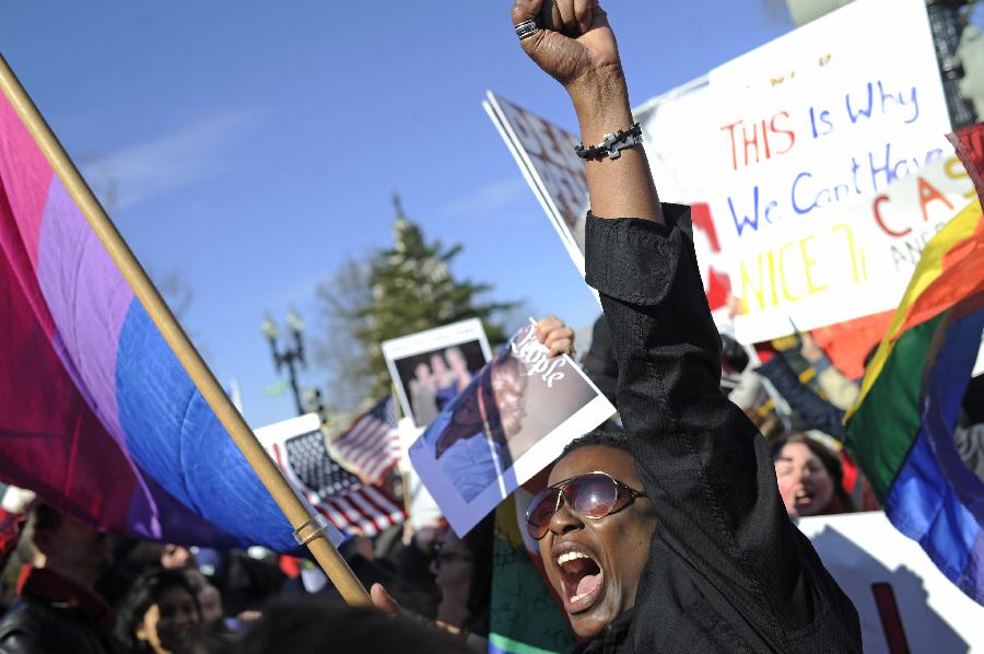 Supporters of same-sex marriage rally outside the U.S. Supreme Court in Washington D.C., capital of the United States, March 27, 2013. The U.S. Supreme Court heard arguments on Wednesday in the case of "United States v. Windsor", whether the Defense of Marriage Act (DOMA) violates the Fifth Amendment's guarantee of equal protection of the laws as applied to persons of the sam sex who are legally married under the laws of their State. (Xinhua/Zhang Jun) 