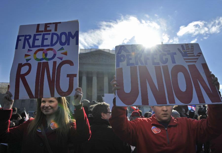 Supporters of same-sex marriage rally outside the U.S. Supreme Court in Washington D.C., capital of the United States, March 27, 2013. The U.S. Supreme Court heard arguments on Wednesday in the case of "United States v. Windsor", whether the Defense of Marriage Act (DOMA) violates the Fifth Amendment's guarantee of equal protection of the laws as applied to persons of the sam sex who are legally married under the laws of their State. (Xinhua/Zhang Jun) 