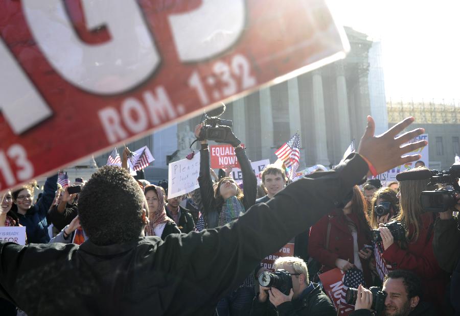 Supporters of same-sex marriage rally outside the U.S. Supreme Court in Washington D.C., capital of the United States, March 27, 2013. The U.S. Supreme Court heard arguments on Wednesday in the case of "United States v. Windsor", whether the Defense of Marriage Act (DOMA) violates the Fifth Amendment's guarantee of equal protection of the laws as applied to persons of the sam sex who are legally married under the laws of their State. (Xinhua/Zhang Jun) 