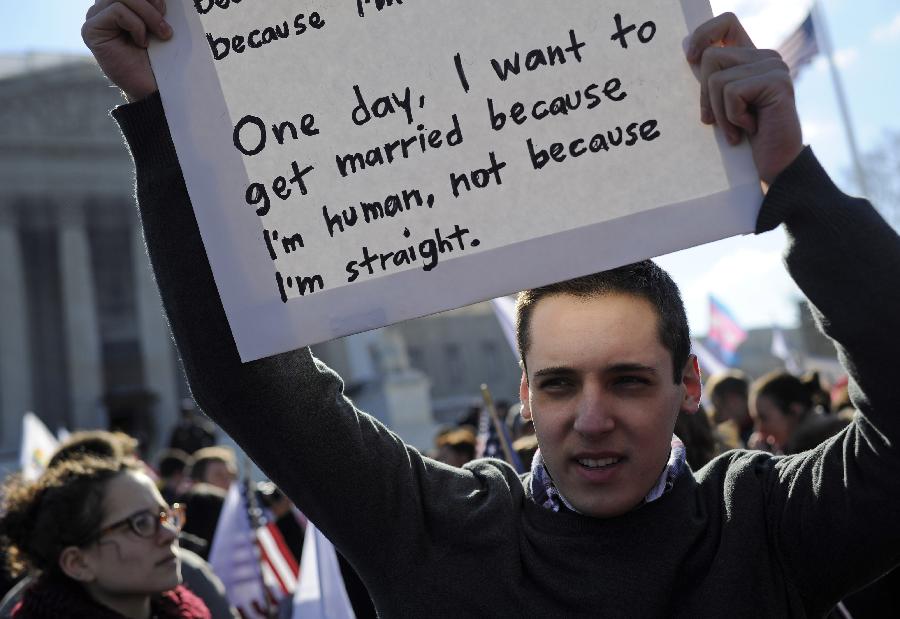 Supporters of same-sex marriage rally outside the U.S. Supreme Court in Washington D.C., capital of the United States, March 27, 2013. The U.S. Supreme Court heard arguments on Wednesday in the case of "United States v. Windsor", whether the Defense of Marriage Act (DOMA) violates the Fifth Amendment's guarantee of equal protection of the laws as applied to persons of the sam sex who are legally married under the laws of their State. (Xinhua/Zhang Jun) 