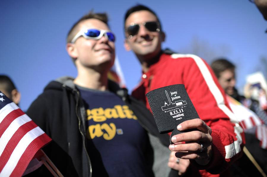 Supporters of same-sex marriage rally outside the U.S. Supreme Court in Washington D.C., capital of the United States, March 27, 2013. The U.S. Supreme Court heard arguments on Wednesday in the case of "United States v. Windsor", whether the Defense of Marriage Act (DOMA) violates the Fifth Amendment's guarantee of equal protection of the laws as applied to persons of the sam sex who are legally married under the laws of their State. (Xinhua/Zhang Jun) 