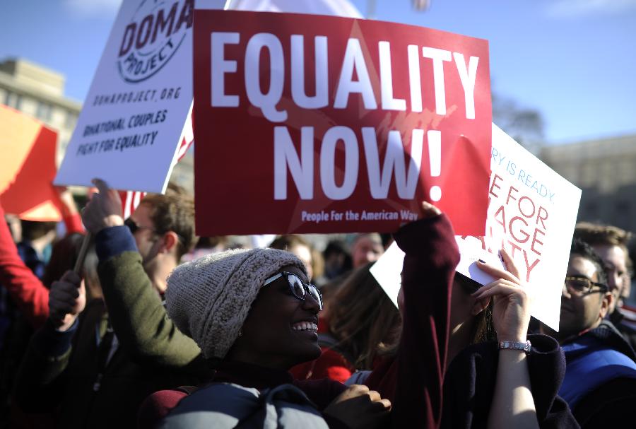 Supporters of same-sex marriage rally outside the U.S. Supreme Court in Washington D.C., capital of the United States, March 27, 2013. The U.S. Supreme Court heard arguments on Wednesday in the case of "United States v. Windsor", whether the Defense of Marriage Act (DOMA) violates the Fifth Amendment's guarantee of equal protection of the laws as applied to persons of the sam sex who are legally married under the laws of their State. (Xinhua/Zhang Jun) 