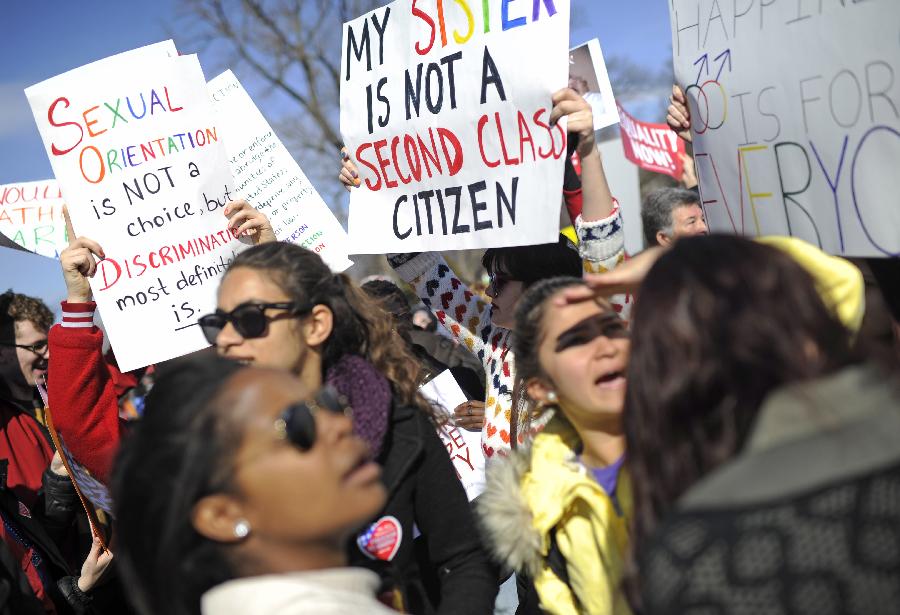 Supporters of same-sex marriage rally outside the U.S. Supreme Court in Washington D.C., capital of the United States, March 27, 2013. The U.S. Supreme Court heard arguments on Wednesday in the case of "United States v. Windsor", whether the Defense of Marriage Act (DOMA) violates the Fifth Amendment's guarantee of equal protection of the laws as applied to persons of the sam sex who are legally married under the laws of their State. (Xinhua/Zhang Jun) 