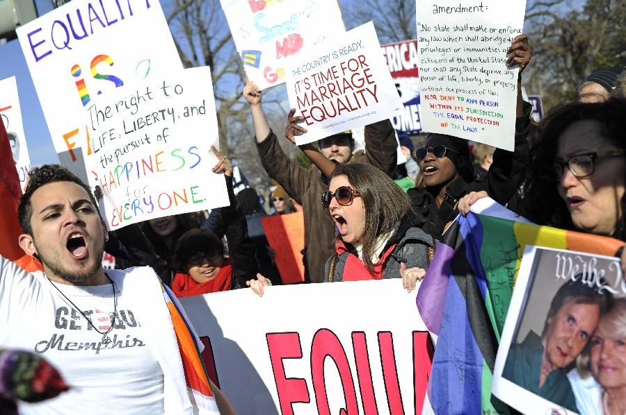 Supporters of same-sex marriage rally outside the U.S. Supreme Court in Washington D.C., capital of the United States, March 27, 2013. The U.S. Supreme Court heard arguments on Wednesday in the case of "United States v. Windsor", whether the Defense of Marriage Act (DOMA) violates the Fifth Amendment's guarantee of equal protection of the laws as applied to persons of the sam sex who are legally married under the laws of their State. (Xinhua/Zhang Jun) 