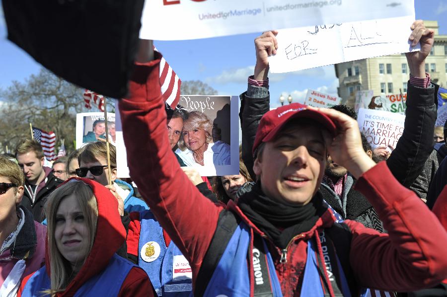 Supporters of same-sex marriage rally outside the U.S. Supreme Court in Washington D.C., capital of the United States, March 27, 2013. The U.S. Supreme Court heard arguments on Wednesday in the case of "United States v. Windsor", whether the Defense of Marriage Act (DOMA) violates the Fifth Amendment's guarantee of equal protection of the laws as applied to persons of the sam sex who are legally married under the laws of their State. (Xinhua/Zhang Jun) 