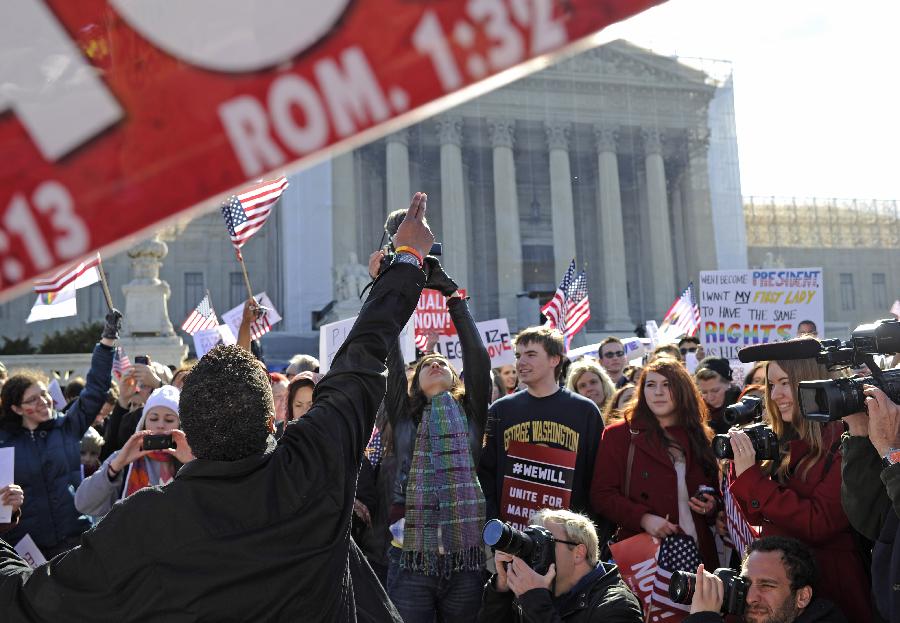 Supporters of same-sex marriage rally outside the U.S. Supreme Court in Washington D.C., capital of the United States, March 27, 2013. The U.S. Supreme Court heard arguments on Wednesday in the case of "United States v. Windsor", whether the Defense of Marriage Act (DOMA) violates the Fifth Amendment's guarantee of equal protection of the laws as applied to persons of the sam sex who are legally married under the laws of their State. (Xinhua/Zhang Jun) 