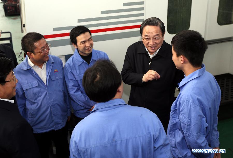 Yu Zhengsheng, a member of the Standing Committee of the Political Bureau of the Communist Party of China (CPC) Central Committee, who is also chairman of the National Committee of the Chinese People's Political Consultative Conference (CPPCC), talks to employees of the Guizhou Aerospace Hongguang Mechanical Manufacturing Co., LTD, in southwest China's Guizhou Province, March 24, 2013. Yu was on an inspection tour in Guizhou from March 24 to March 27. (Xinhua/Yao Dawei) 