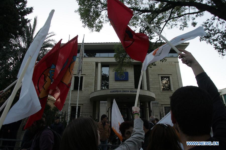 Thousands of Cypriots demonstrate to protest against the harsh treatment imposed on Cyprus by the Eurogroup, in the streets of Nicosia, Cyprus on March 27, 2013. The Mediterranean island and the Troika struck a 10 billion euro bailout deal in Brussels on March 25. The new agreement requires radical reshaping of the Cypriot banking system and massive "haircuts" on Cypriots who have more than 100,000 Euros deposited in banks. Many bank employees may lose their jobs. (Xinhua/Marios Lolos) 