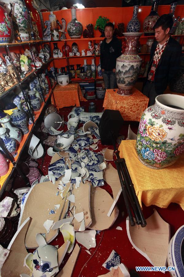 Chinawares are torn down by strong wind and fall into pieces at a shop in Liuzhou City, south China's Guangxi Zhuang Autonomous Region, March 28, 2013. Strong wind and thunder hit the city on Thursday. (Xinhua/Zhang Cunli)