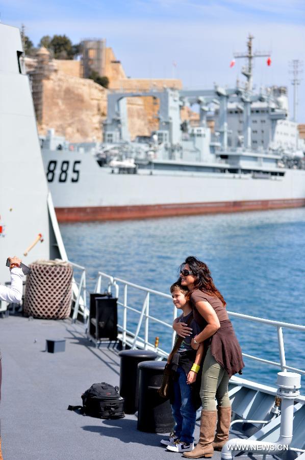 Visitors pose for photos on the Chinese frigate "Hengyang" at the grand habour of Valletta, Malta, on March 27, 2013. An Open Day of the "Hengyang" for Maltese was held on Wednesday. The 13th naval escort squad, sent by the Chinese People's Liberation Army (PLA) Navy, arrived at Valletta of Malta on Tuesday for a five-day visit after finishing its escort missions. (xinhua/Xu Nizhi)
