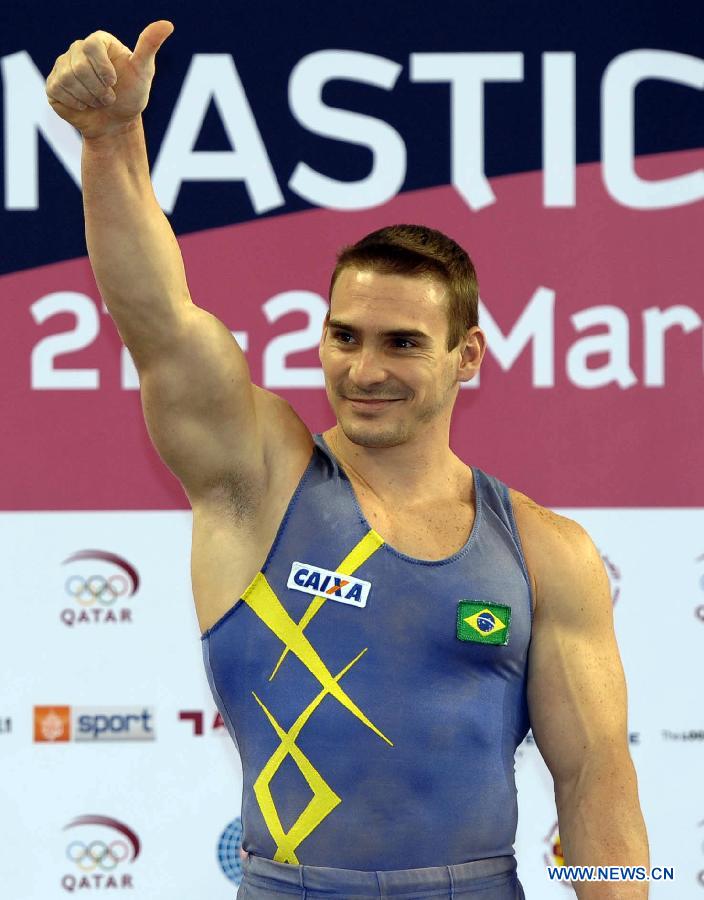 Arthur Nabarrete of Brazil celebrates during the victory ceremony for Men's Rings at the FIG Artistic Gymnastics World Challenge cup in Doha, capital of Qatar, March 28, 2013. Nabarrete won the gold with 15.700. (Xinhua/Chen Shaojin)