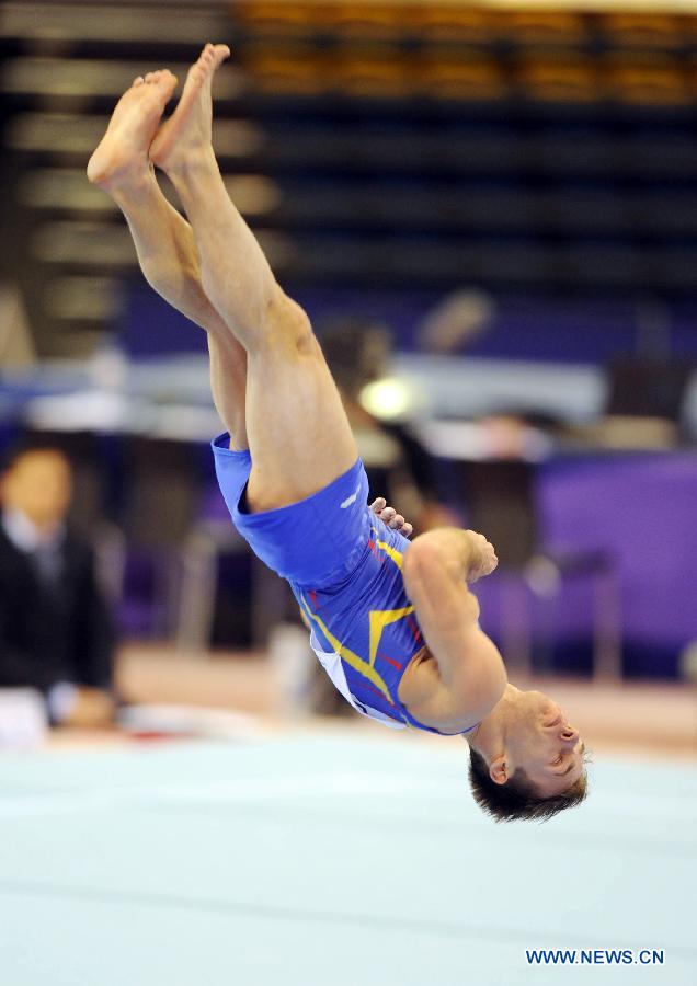 Flavius Koczi of Romania competes during Men's Floor Final at the FIG Artistic Gymnastics World Challenge cup in Doha, capital of Qatar, March 28, 2013. Koczi won the gold with 14.925. (Xinhua/Chen Shaojin)