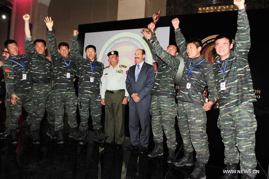 Members of Chinese People's Armed Police team receive the first prize of the 5th Warrior Competition in Amman, Jordan, March 28, 2013. Chinese People's Armed Police team on Thursday won the first prize of fifth Warriors contest "international special forces contest at King Abdullah Special Operation Training Center (KASOTC) in Amman. The competition with wide participation of 33 teams from 18 countries was held from March 24 to March 28. (Xinhua/Cheng Chunxiang)  