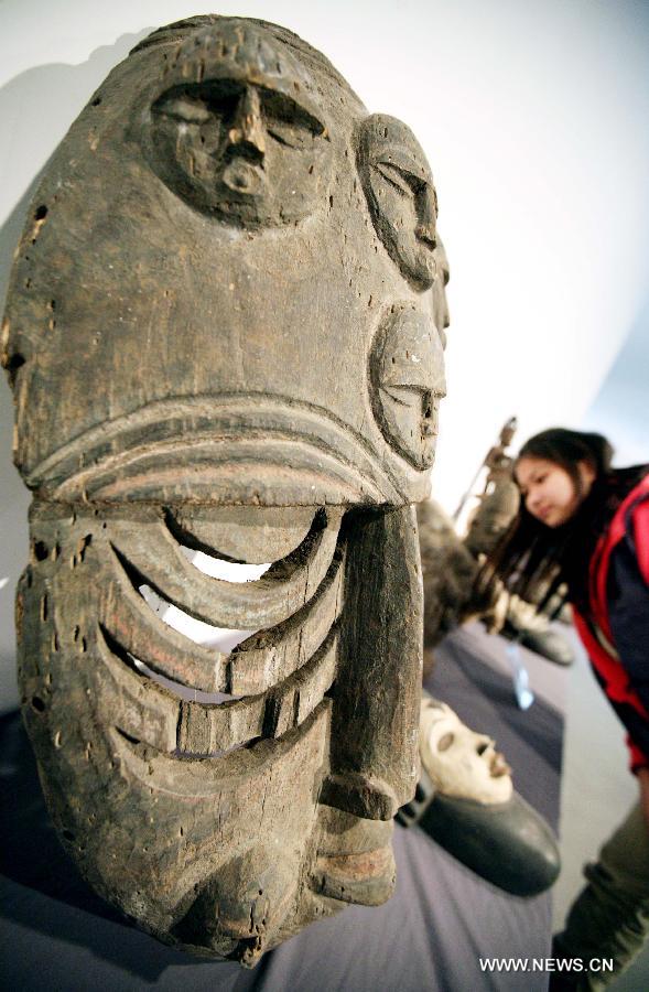 A visitor views a wood sculpture at the African Wood Sculpture Collection exhibition in Nanjing, capital of east China's Jiangsu Province, March 29, 2013. The exhibition kicking off on Friday displays nearly 600 wood carving works from dozens of countries in the sub-Saharan Africa. (Xinhua/Wang Xin) 