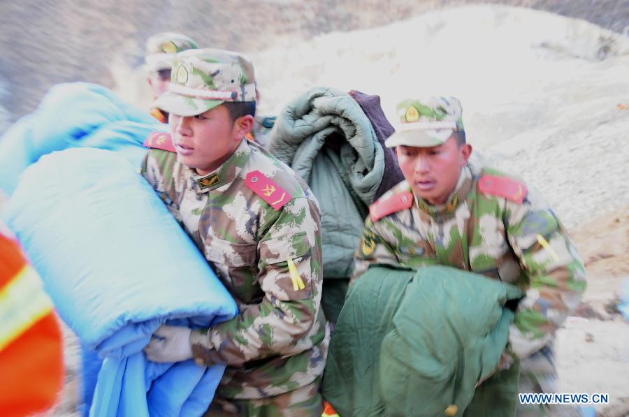 Rescuers work at the accident site after a major landslide hit a mining area of Tibet Huatailong Mining Development Co. Ltd, a subsidiary of the China National Gold Group Corporation, in Maizhokunggar County of Lhasa, capital of southwest China's Tibet Autonomous Region, March 30, 2013. A total of 83 workers were buried in the landslide, which happened on Friday morning. Rescuers have not yet found survivors or bodies 28 hours after the massive landslide. (Xinhua/Zhang Quan) 