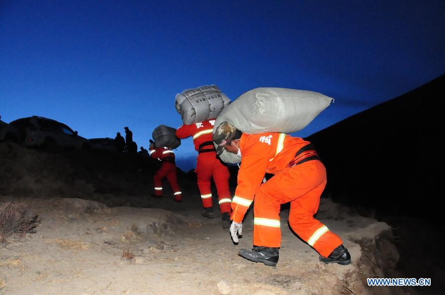 Rescuers work at the accident site after a major landslide hit a mining area of Tibet Huatailong Mining Development Co. Ltd, a subsidiary of the China National Gold Group Corporation, in Maizhokunggar County of Lhasa, capital of southwest China's Tibet Autonomous Region, March 30, 2013. A total of 83 workers were buried in the landslide, which happened on Friday morning. Rescuers have not yet found survivors or bodies 28 hours after the massive landslide. (Xinhua/Zhang Quan) 