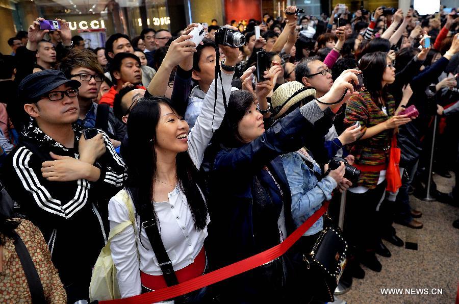Fans take pictures at an exhibition for paying tribute to Cheung in Hong Kong, south China, March 30, 2013. The exhibition is held to mark the 10th anniversary of the death of Leslie Cheung, who leapt to his death from a hotel in Hong Kong on April 1, 2003. A total of 1,900,119 origami cranes, folded by fans around the world, are displayed inside a giant red cube, which broke the Guinness World Record as "the largest display of origami cranes". (Xinhua/Chen Xiaowei)