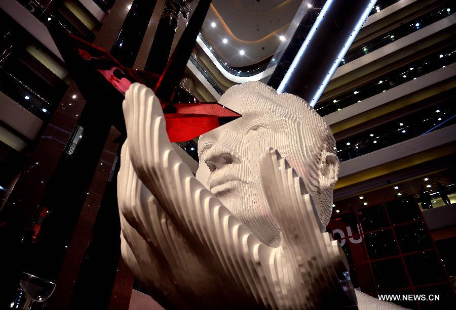 A five-metre-high sculpture of late Hong Kong singer Leslie Cheung is seen displayed at an exhibition for paying tribute to Cheung in Hong Kong, south China, March 30, 2013. The exhibition is held to mark the 10th anniversary of the death of Leslie Cheung, who leapt to his death from a hotel in Hong Kong on April 1, 2003. A total of 1,900,119 origami cranes, folded by fans around the world, are displayed inside a giant red cube, which broke the Guinness World Record as "the largest display of origami cranes". (Xinhua/Chen Xiaowei)