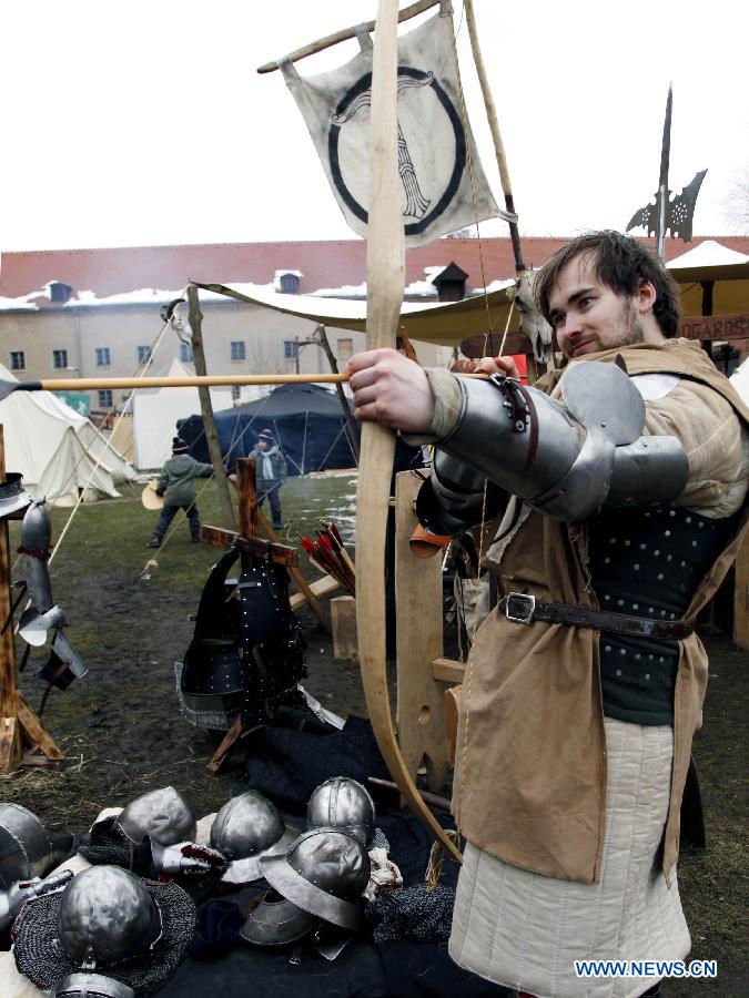 A man performs archery during the annual Knight Festival, which opened in the Spandau Zitadelle (Citadel) in Berlin, March 30, 2013. A wide range of activities presenting the life and scene dating back to the European medieval times at the 3-day Knight Festival attracts many Berliners on outing during their Easter vacation. (Xinhua/Pan Xu)