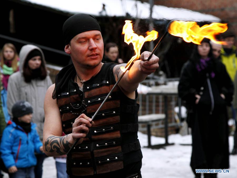 A man shows his stunt with fire during the annual Knight Festival, which opened in the Spandau Zitadelle (Citadel) in Berlin, March 30, 2013. A wide range of activities presenting the life and scene dating back to the European medieval times at the 3-day Knight Festival attracts many Berliners on outing during their Easter vacation. (Xinhua/Pan Xu)