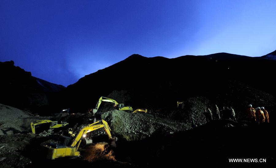 Rescue workers conduct search and rescue work at the site where a large-scale landslide hit a mining area in Maizhokunggar County of Lhasa, southwest China's Tibet Autonomous Region, March 30, 2013. Rescuers have found bodies and are still searching for survivors more than 37 hours after a massive landslide buried 83 miners at the polymetal mine in Tibet. (Xinhua/Purbu Zhaxi)