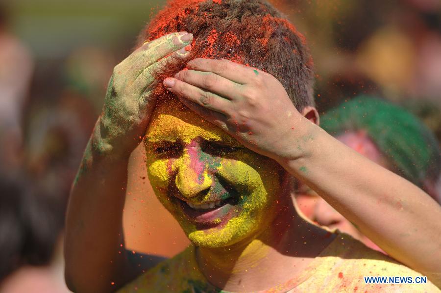 Students of University of British Columbia sing and throw coloured powder on each other as they celebrate Holi, the Indian Festival of Colors, in Vancouver, Canada, on March 30, 2013. Holi is all about celebrating the colors and vitality of spring, with family and friends. (Xinhua/Sergei Bachlakov) 