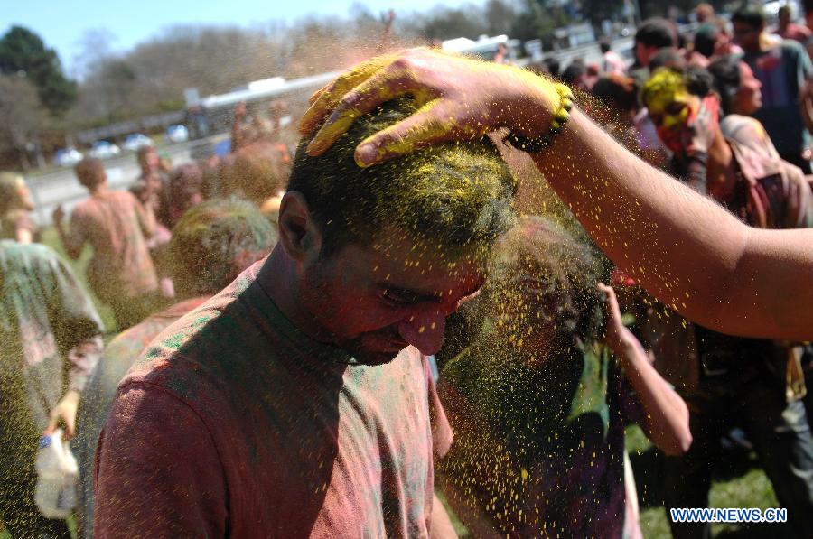 Students of University of British Columbia sing and throw coloured powder on each other as they celebrate Holi, the Indian Festival of Colors, in Vancouver, Canada, on March 30, 2013. Holi is all about celebrating the colors and vitality of spring, with family and friends. (Xinhua/Sergei Bachlakov) 