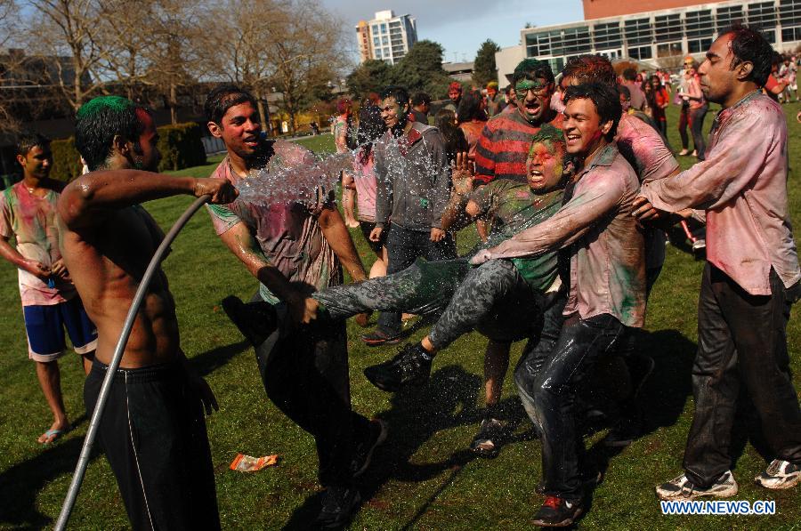 Students of University of British Columbia sing and throw coloured powder on each other as they celebrate Holi, the Indian Festival of Colors, in Vancouver, Canada, on March 30, 2013. Holi is all about celebrating the colors and vitality of spring, with family and friends. (Xinhua/Sergei Bachlakov) 