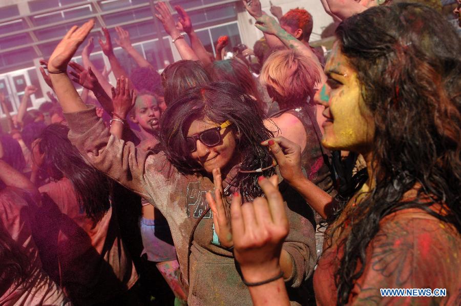 Students of University of British Columbia sing and throw coloured powder on each other as they celebrate Holi, the Indian Festival of Colors, in Vancouver, Canada, on March 30, 2013. Holi is all about celebrating the colors and vitality of spring, with family and friends. (Xinhua/Sergei Bachlakov) 