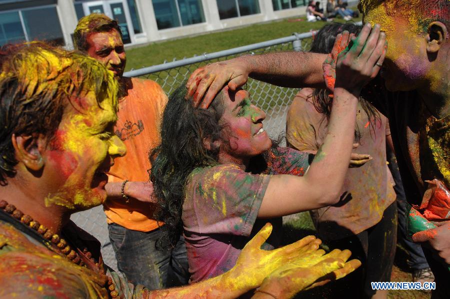 Students of University of British Columbia sing and throw coloured powder on each other as they celebrate Holi, the Indian Festival of Colors, in Vancouver, Canada, on March 30, 2013. Holi is all about celebrating the colors and vitality of spring, with family and friends. (Xinhua/Sergei Bachlakov) 