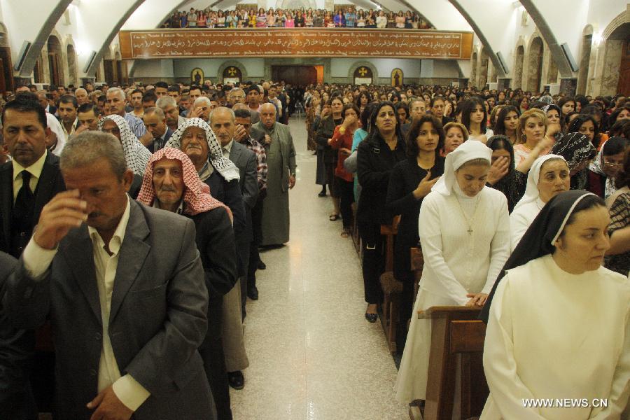 Iraqi Christians take part in an Easter mass in Church of Mar Behnam in Hamdaniya town, Iraq, on March 31, 2013. (Xinhua/Yaser Jawad) 