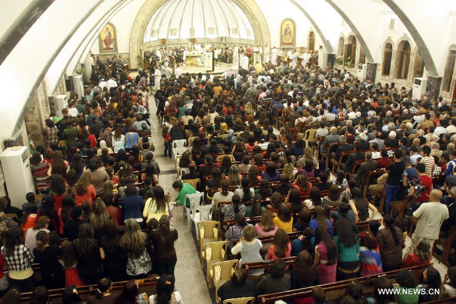 Iraqi Christians take part in an Easter mass in Church of Mar Behnam in Hamdaniya town, Iraq, on March 31, 2013. (Xinhua/Yaser Jawad)