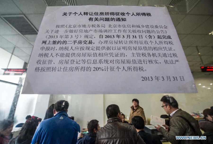 Citizens pay taxes for housing transaction at the Sixth Taxation Office of Chaoyang District Local Taxation Bureau on the first working day after the Beijing government announced detailed property curbs in Beijing, capital of Beijing, April 1, 2013. The municipal government of Beijing on March 30 spelled out detailed rules aimed at cooling the property market following the central government's fresh regulatory plan earlier this month. Single adults with a permanent Beijing residence registration, who have not made purchases in the city before, are allowed to buy only one apartment, according to the announcement. Meanwhile, the city will raise down payments for second-home buyers and vow to strictly implement the 20-percent tax on capital gains from property sales. (Xinhua/Luo Xiaoguang)