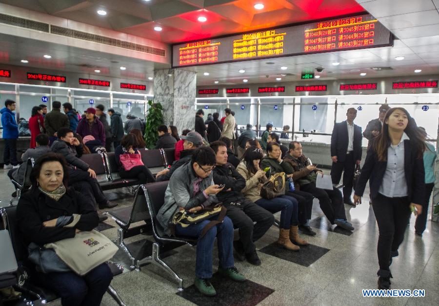 Citizens wait for handling procedures for housing transaction at the hall of the Chaoyang District Housing Registration and Certification Center on the first working day after the Beijing government announced detailed property curbs in Beijing, capital of Beijing, April 1, 2013. The municipal government of Beijing on March 30 spelled out detailed rules aimed at cooling the property market following the central government's fresh regulatory plan earlier this month. Single adults with a permanent Beijing residence registration, who have not made purchases in the city before, are allowed to buy only one apartment, according to the announcement. Meanwhile, the city will raise down payments for second-home buyers and vow to strictly implement the 20-percent tax on capital gains from property sales. (Xinhua/Luo Xiaoguang)