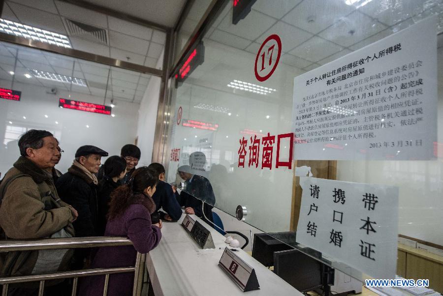 Citizens queue to inquire the new housing transaction policy at the Sixth Taxation Office of Chaoyang District Local Taxation Bureau on the first working day after the Beijing government announced detailed property curbs in Beijing, capital of Beijing, April 1, 2013. The municipal government of Beijing on March 30 spelled out detailed rules aimed at cooling the property market following the central government's fresh regulatory plan earlier this month. Single adults with a permanent Beijing residence registration, who have not made purchases in the city before, are allowed to buy only one apartment, according to the announcement. Meanwhile, the city will raise down payments for second-home buyers and vow to strictly implement the 20-percent tax on capital gains from property sales. (Xinhua/Luo Xiaoguang)