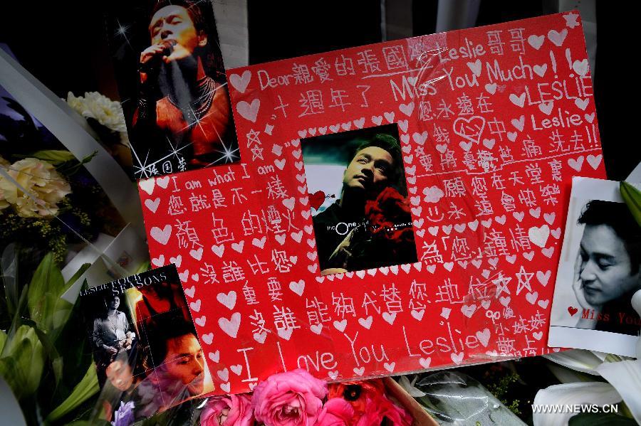 A placard is seen at a commemoration of the 10th anniversary of Hong Kong singer and actor Leslie Cheung's death outside the Mandarin Oriental Hotel in Hong Kong, south China, April 1, 2013. Leslie killed himself by leaping off a balcony on the 24th floor of the Mandarin Oriental Hotel on April 1, 2003. (Xinhua/Chen Xiaowei) 