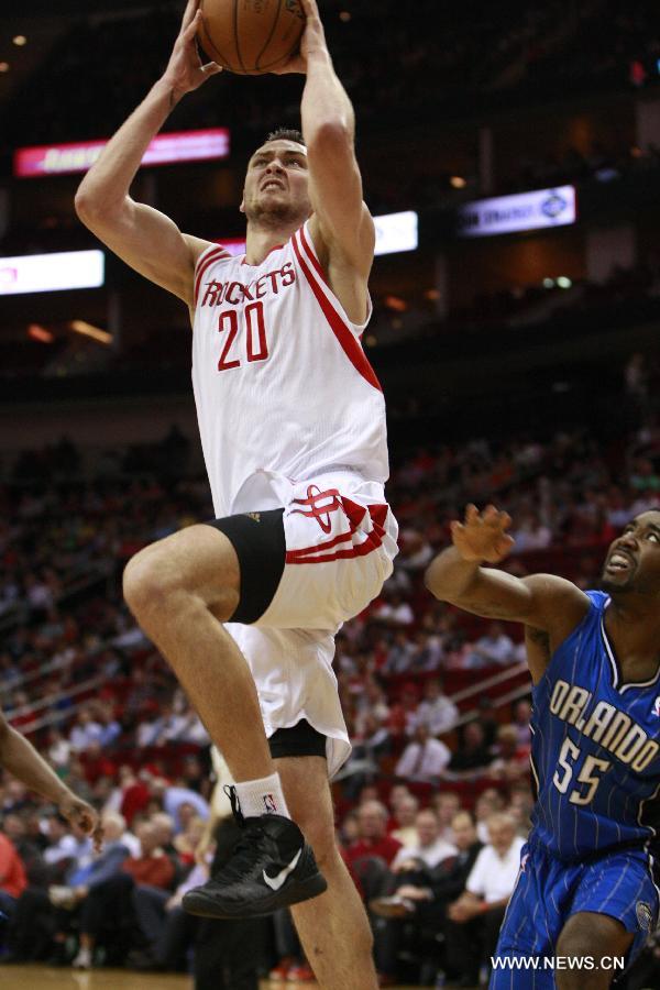 Houston Rockets' Donatas Motiejunas (Top) goes to the basket during the NBA basketball game against Orlando Magic in Toronto, Canada, April 1, 2013. Rockets won 111-103. (Xinhua/Song Qiong)