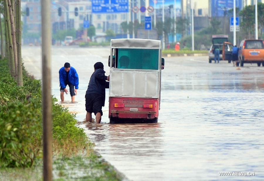 A man pushes his tricycle on the flooded Lingxiu Road in Nanning, capital of south China's Guangxi Zhuang Autonomous Region, April 2, 2013. Parts of the autonomous region, including Nanning, Yulin and Qinzhou, witnessed a heavy rainfall on Tuesday, where rainstorm alerts have been issued by local meteorological authorities. (Xinhua/Huang Xiaobang)  