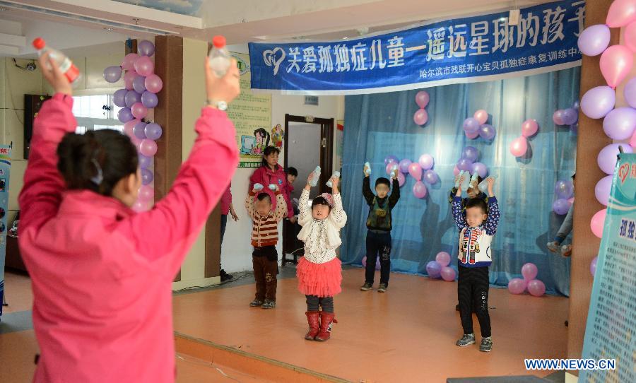 Autistic children perform at a rehabilitation center in Harbin, capital of northeast China's Heilongjiang Province, April 2, 2013, on the occasion of the World Autism Awareness Day. (Xinhua/Wang Kai)
