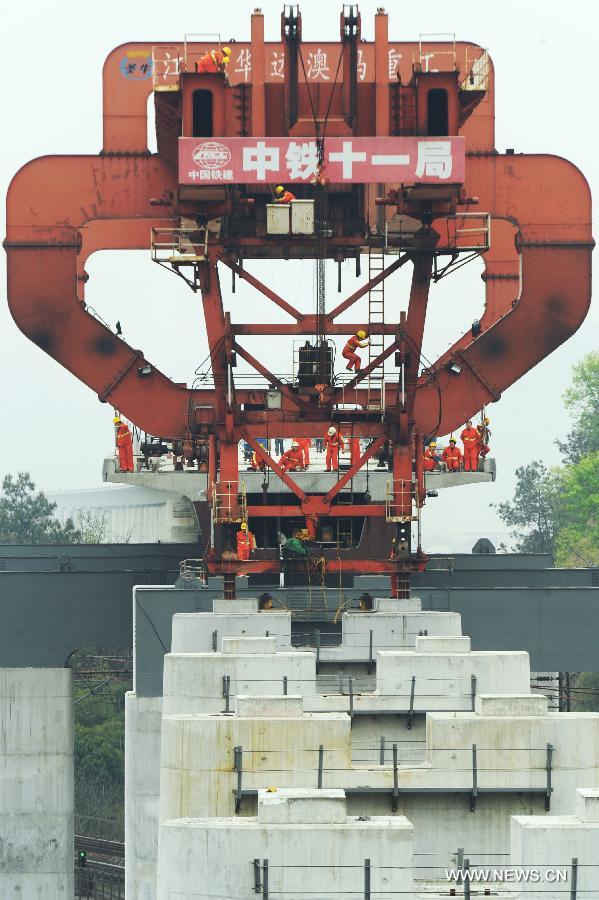 Workers work at the construction site of the Yiwu section of the Hangzhou-Changsha High-speed Rail on the Dongte Bridge in Yiwu, east China's Zhejiang Province, April 1, 2013. The 920-kilometer-long Hangzhou-Changsha High-speed Rail would shorten the travelling time between east China's Hangzhou and central China's Changsha from 6.3 hours to 3 hours once completed. (Xinhua/Tan Jin)